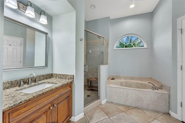 bathroom featuring a garden tub, a shower stall, tile patterned flooring, and vanity