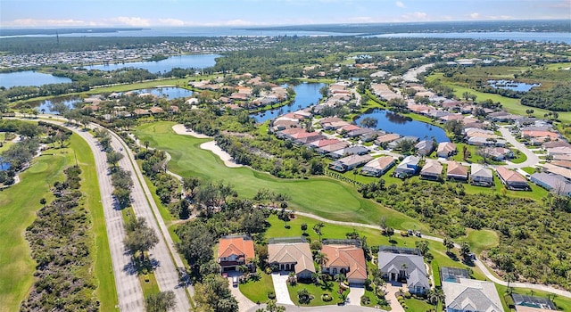 birds eye view of property featuring a water view, view of golf course, and a residential view