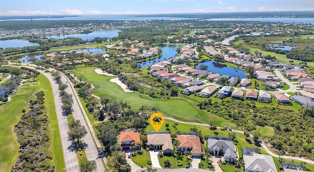 aerial view with a residential view, a water view, and golf course view