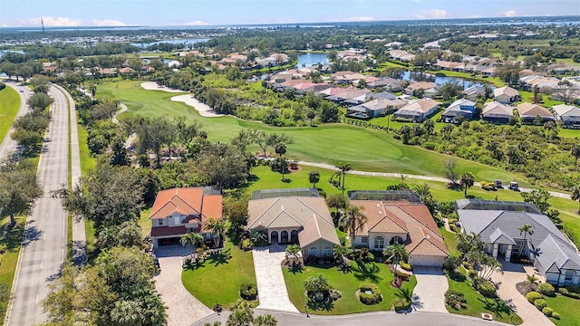 birds eye view of property with a water view, a residential view, and golf course view