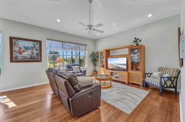 living room with a ceiling fan, recessed lighting, baseboards, and wood finished floors