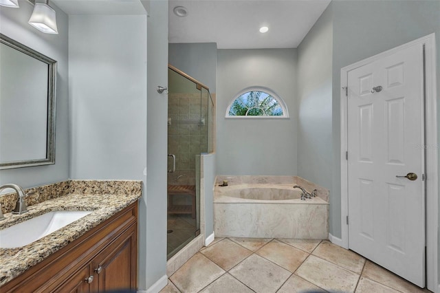 full bathroom with a garden tub, vanity, baseboards, tile patterned floors, and a stall shower