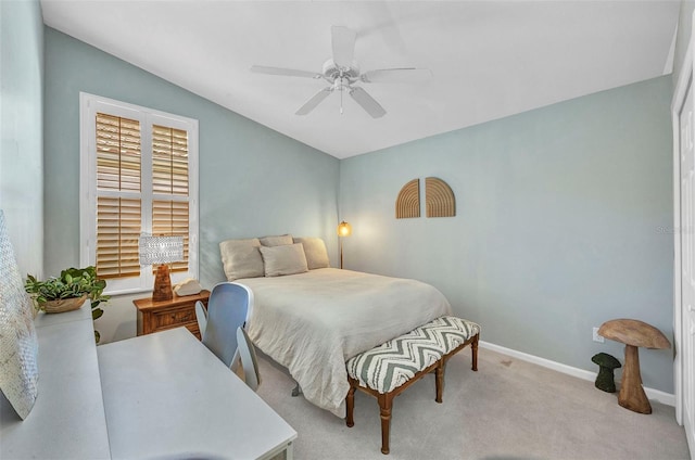 carpeted bedroom with a ceiling fan and baseboards