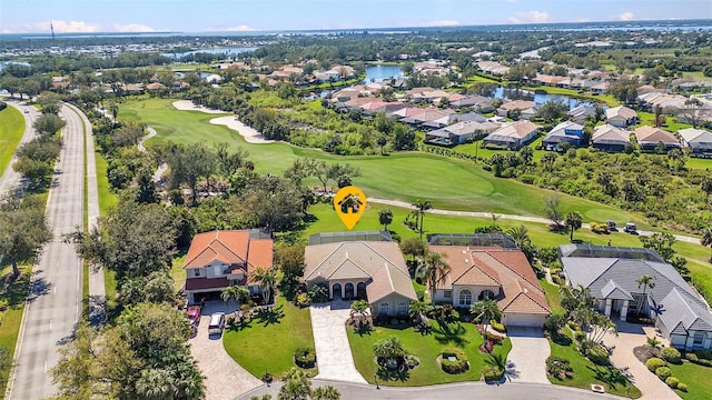 bird's eye view with golf course view, a water view, and a residential view