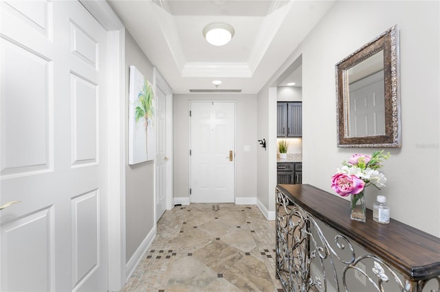 entryway featuring recessed lighting, baseboards, a raised ceiling, and crown molding