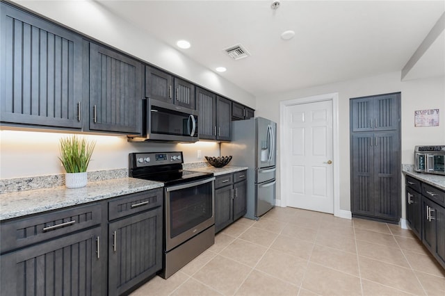 kitchen featuring visible vents, recessed lighting, stainless steel appliances, light tile patterned flooring, and light stone countertops