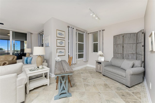 living room featuring track lighting and baseboards