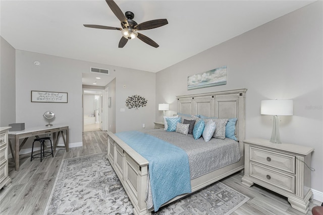 bedroom featuring visible vents, baseboards, and light wood finished floors