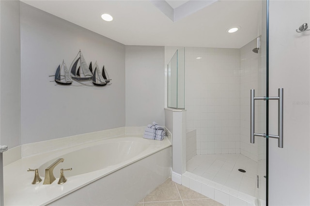 full bath featuring tile patterned floors, a bath, recessed lighting, and a tile shower