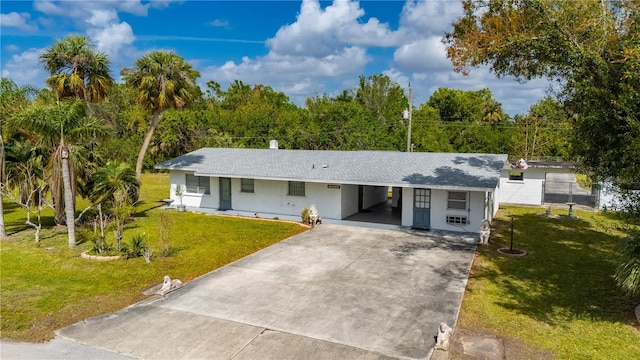 single story home with a front lawn, a carport, and concrete driveway