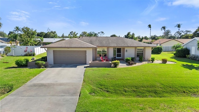 single story home with a front lawn, concrete driveway, an attached garage, and stucco siding