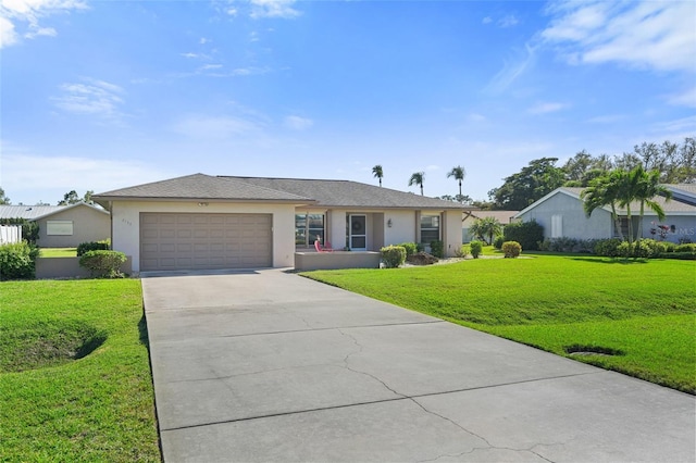 single story home featuring a garage, a front yard, driveway, and stucco siding