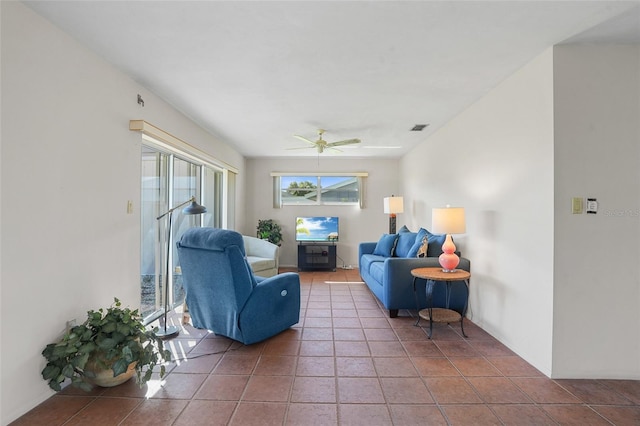 living room featuring a ceiling fan, light tile patterned flooring, and visible vents