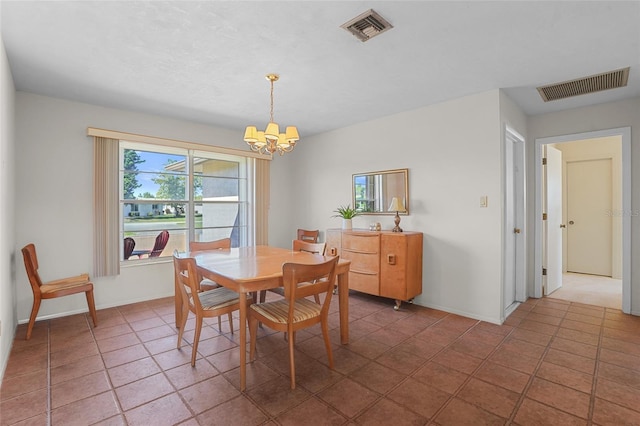 tiled dining room featuring baseboards, visible vents, and an inviting chandelier