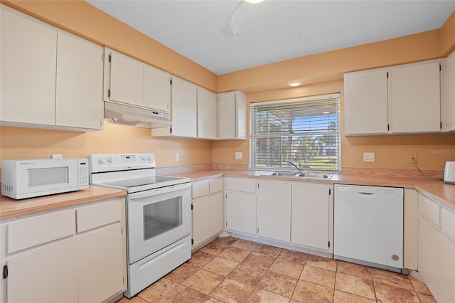 kitchen with light countertops, white cabinets, a sink, white appliances, and under cabinet range hood