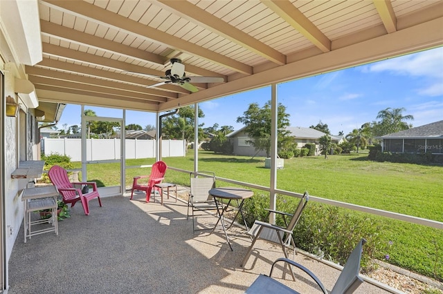 sunroom / solarium with ceiling fan and beamed ceiling