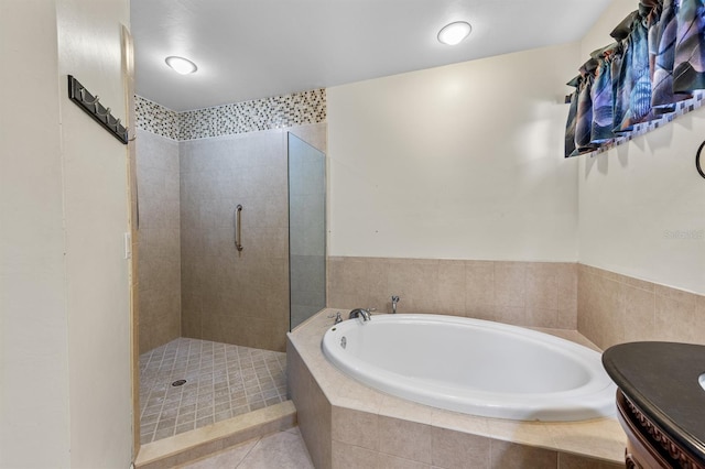 bathroom featuring tiled shower, vanity, a bath, and tile patterned floors