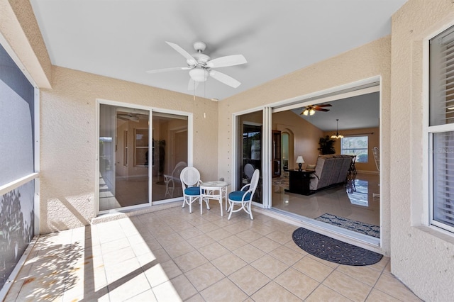 sunroom / solarium with a ceiling fan