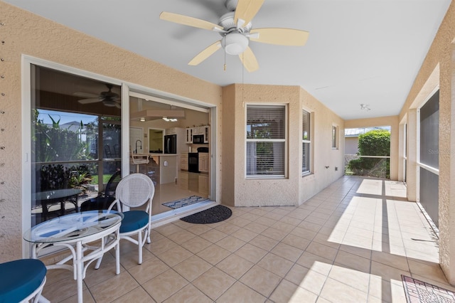 view of patio featuring ceiling fan and a sink