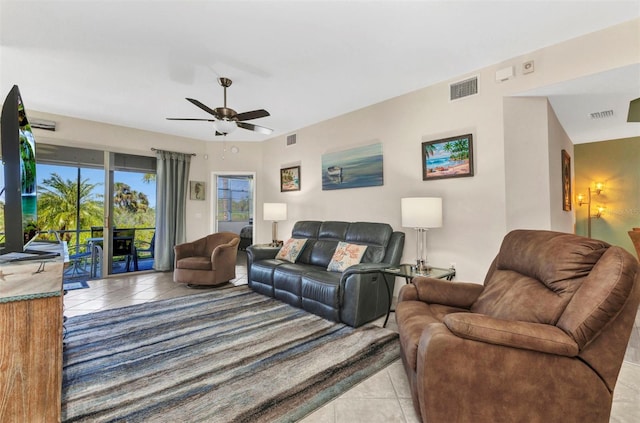 tiled living area with visible vents and ceiling fan