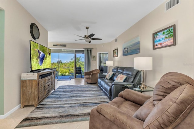 living area featuring visible vents, baseboards, light tile patterned flooring, and a ceiling fan