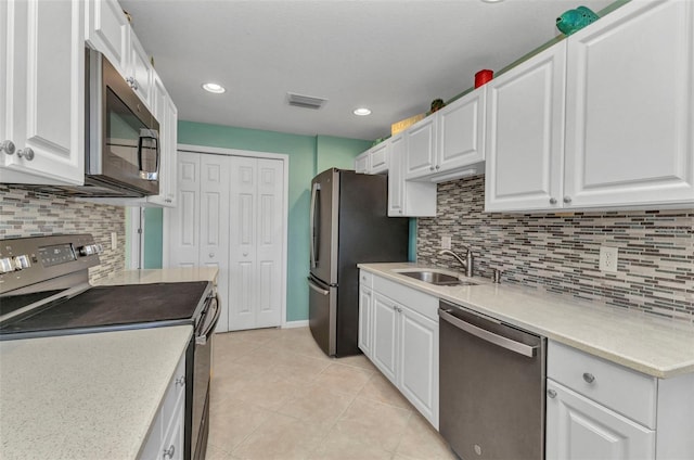 kitchen with visible vents, light countertops, appliances with stainless steel finishes, white cabinetry, and a sink