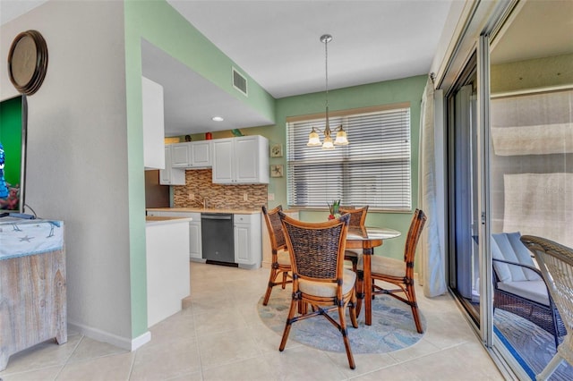 dining room with an inviting chandelier, light tile patterned flooring, visible vents, and baseboards