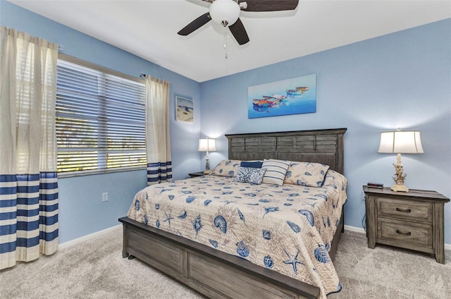 bedroom with ceiling fan, baseboards, and carpet