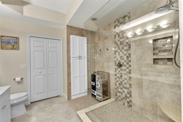 full bathroom featuring tile patterned floors, walk in shower, toilet, a closet, and vanity