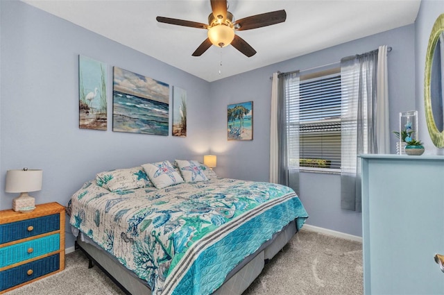 carpeted bedroom with a ceiling fan and baseboards