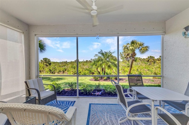 sunroom featuring a ceiling fan