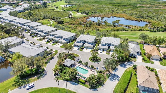 aerial view with a residential view, view of golf course, and a water view