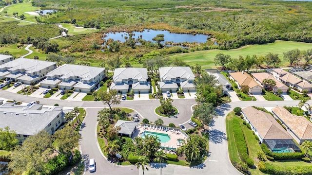 birds eye view of property featuring view of golf course, a water view, and a residential view