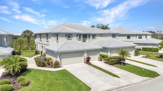 view of front of home featuring stucco siding, central air condition unit, driveway, a tile roof, and a front yard