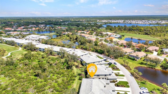 drone / aerial view with a residential view and a water view