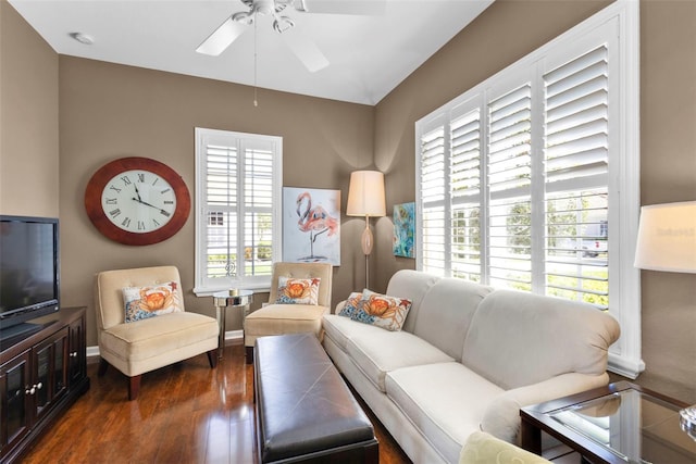 living room with wood finished floors, baseboards, and ceiling fan