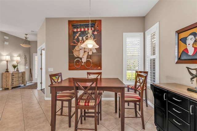 dining space with light tile patterned floors and baseboards