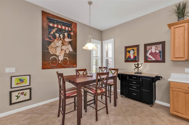 dining room featuring light tile patterned flooring and baseboards