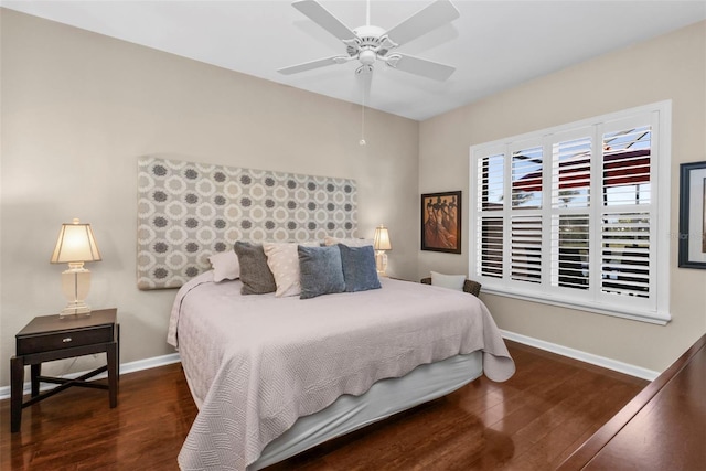 bedroom with ceiling fan, baseboards, and wood finished floors