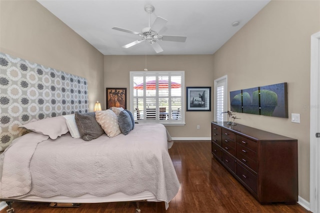 bedroom featuring a ceiling fan, dark wood-type flooring, and baseboards