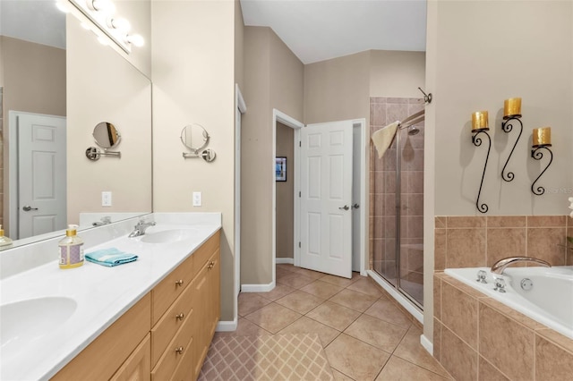 bathroom with tile patterned flooring, a shower stall, a garden tub, double vanity, and a sink