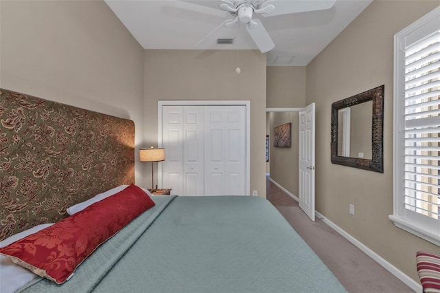 carpeted bedroom featuring visible vents, baseboards, a closet, and a ceiling fan