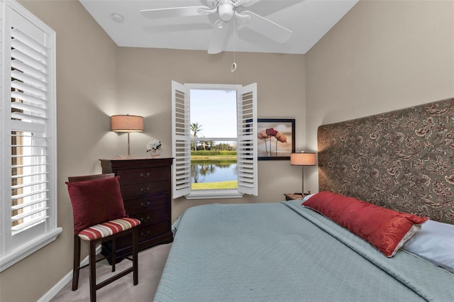 carpeted bedroom with baseboards and ceiling fan