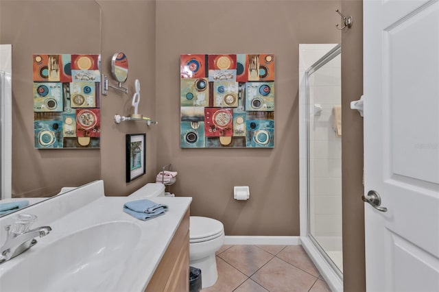 full bath with baseboards, toilet, tiled shower, tile patterned floors, and vanity