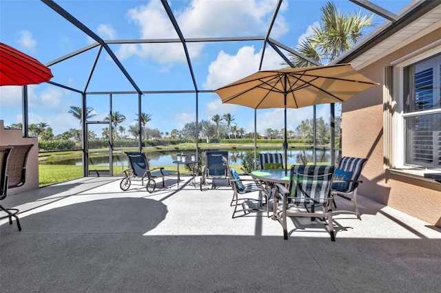 view of patio / terrace featuring outdoor dining space, a lanai, and a water view