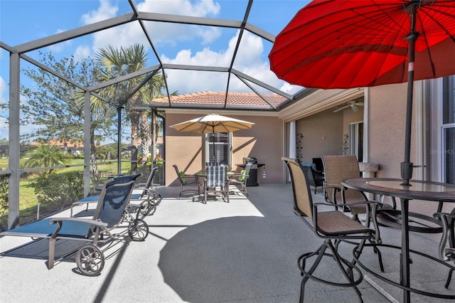 view of patio / terrace with a lanai and ceiling fan