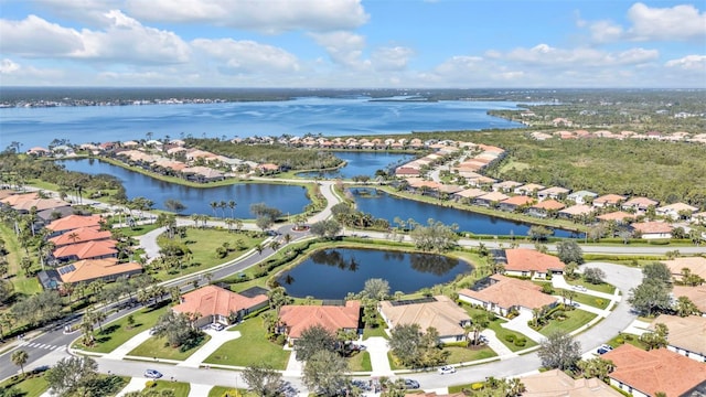 drone / aerial view with a residential view and a water view