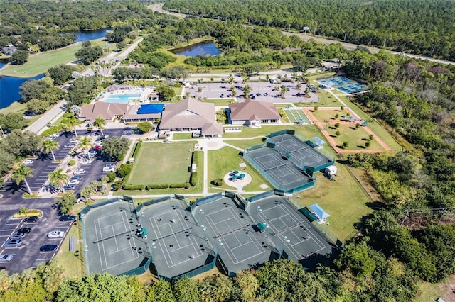 birds eye view of property featuring a view of trees and a water view