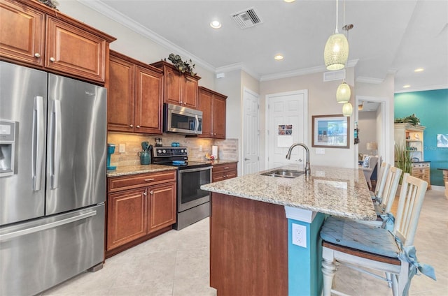 kitchen featuring visible vents, a sink, tasteful backsplash, stainless steel appliances, and light stone countertops