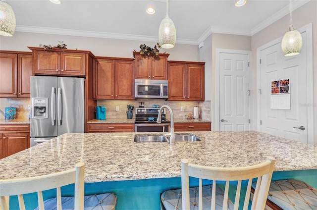 kitchen with light stone counters, backsplash, appliances with stainless steel finishes, and a sink